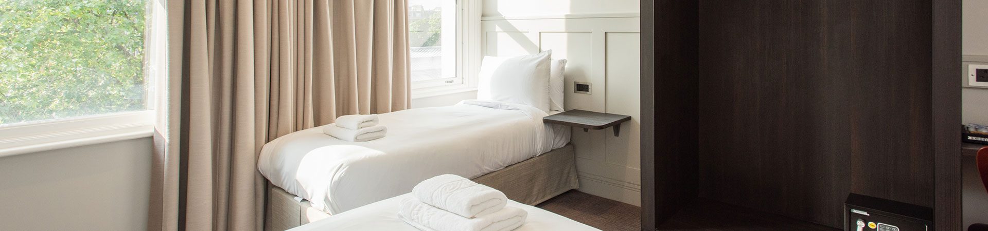 Twin hotel room with two single beds and stylish interior furnishings | Mowbray Court Hotel Earls Court